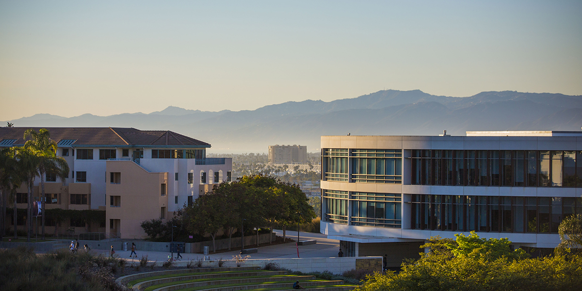 Hannon Library and Lawton Plaza at twilight with the mountains in the background.